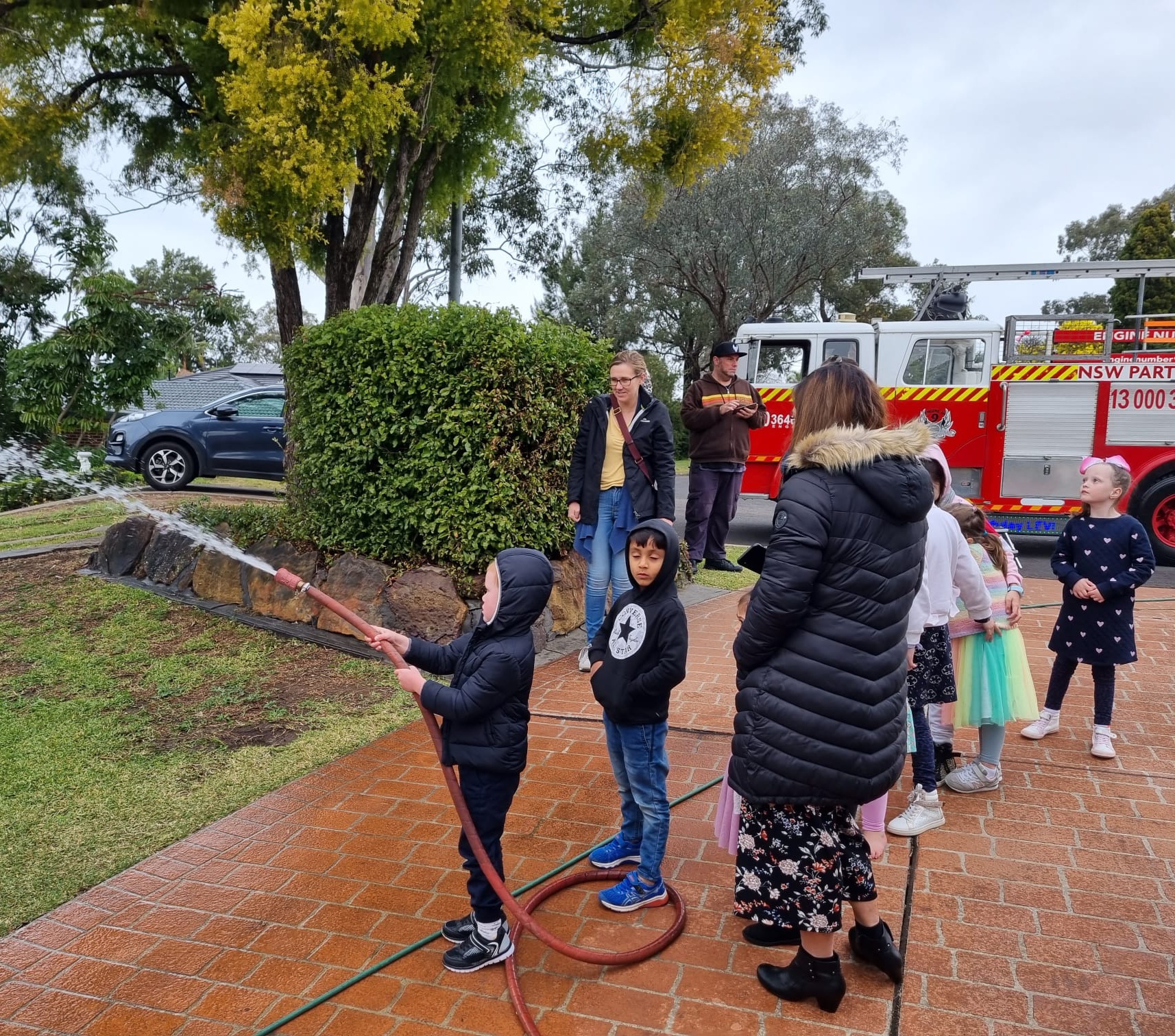 Children enjoying fire hose fun with NSW Party Brigade
